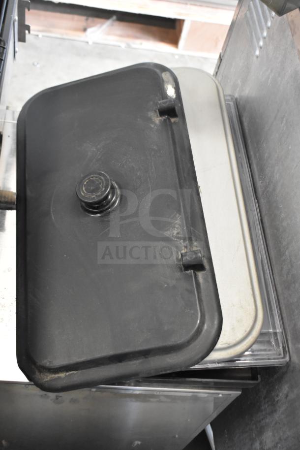 "Assorted ice cream and frozen beverage machine parts, including lids and trays. Used condition with visible wear."