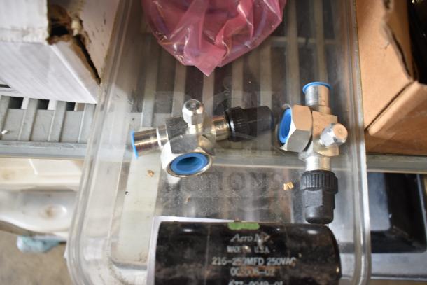 31 various items including metal spigots and a black drip tray, suitable for plumbing or industrial use.