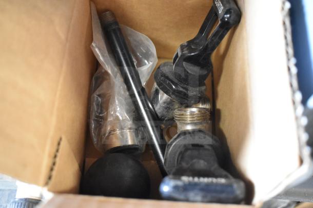 Box containing 31 various items including spigots, a mixing cup collar, and a drip tray. Items appear used. Marked with “Curtis.”