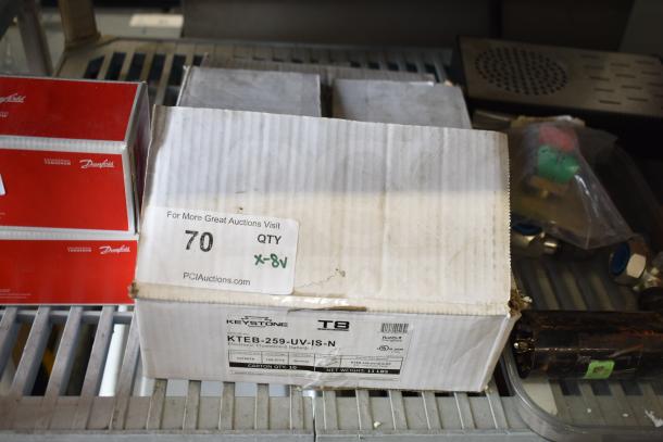 Box of 8 Keystone T8 ballasts, model KTEB-259-UV-IS-N, in original packaging, electronic fluorescent light use.