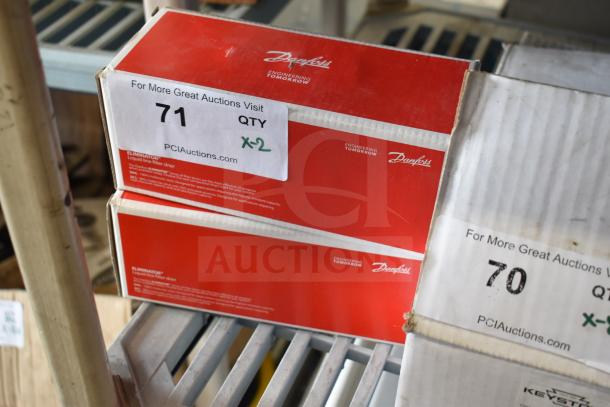 Two Danfoss Eliminator filter driers in red boxes, auction tag labeled "71 QTY x2," on a shelving unit.