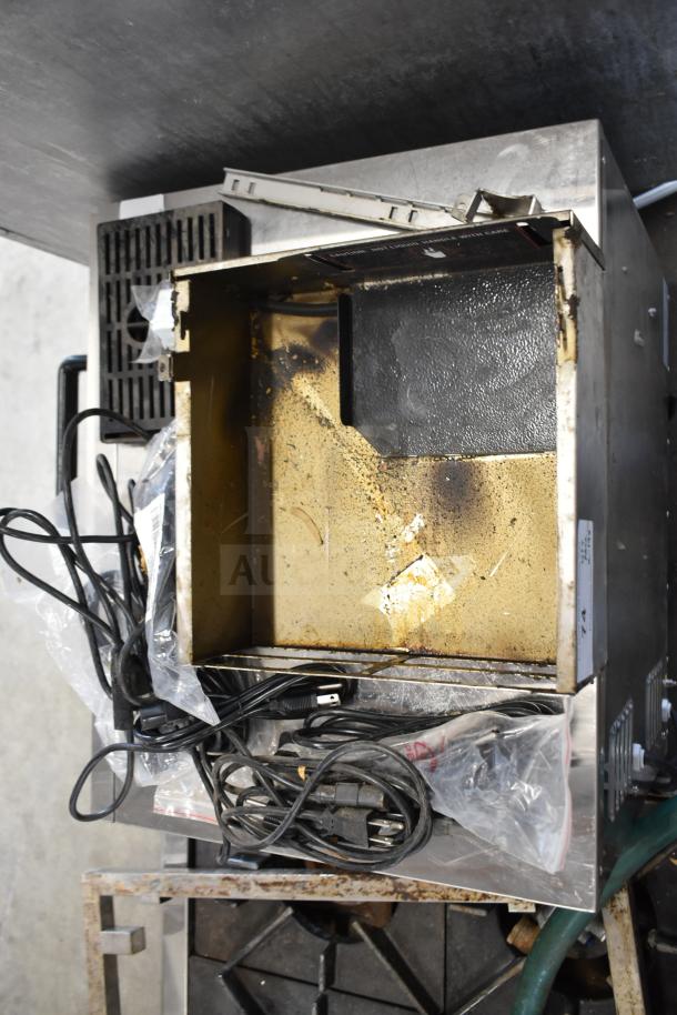 Various items including wires and a drip tray in used condition, showing signs of wear. Includes multiple cables.