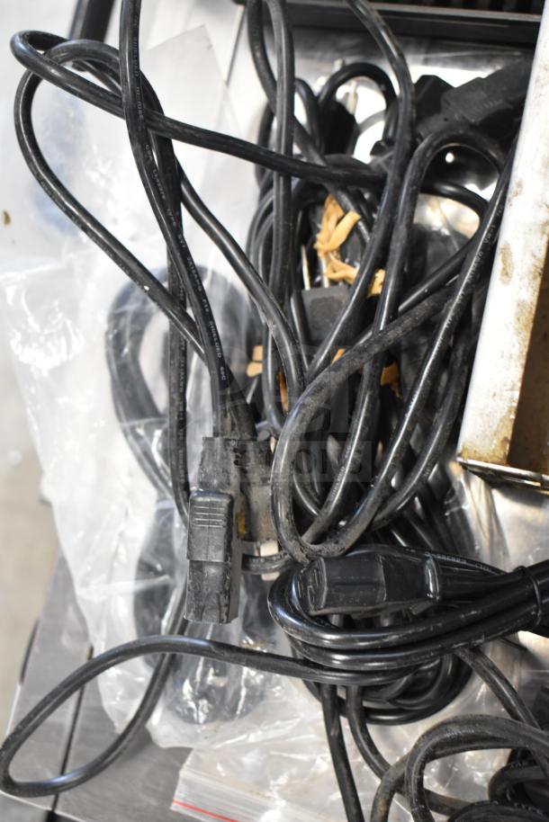 Tangled black wires and a drip tray, mixed condition, part of a lot of 19 items. Ideal for electronics and repair needs.