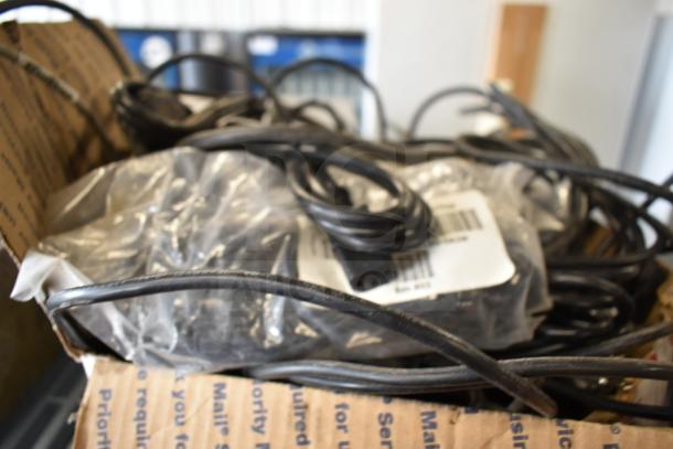 Box containing various items, including coiled wires and an air pot, scattered inside with visible barcode labels.