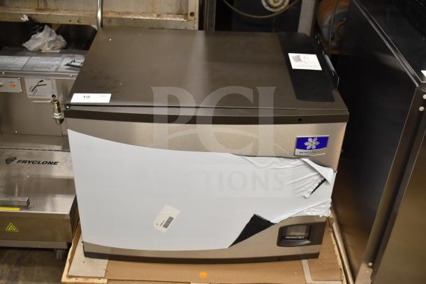 Brand new Manitowoc IYT0750A-261 ice machine, 30" wide, 672 lb capacity, visible dent on side, 208-230V, 1 phase.