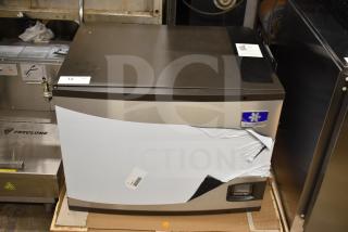 Brand new Manitowoc IYT0750A-261 ice machine, 30" wide, 672 lb capacity, visible dent on side, 208-230V, 1 phase.