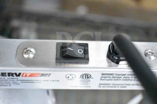Brand new ServIt 423BLS3 3-bulb heat lamp with visible scratch and dent. Voltage: 120V, 1 Phase. Safety labels present.