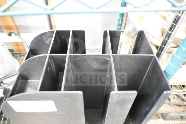 Black poly lid dispenser with multiple compartments, used condition. Ideal for organizing and storing various lid sizes.