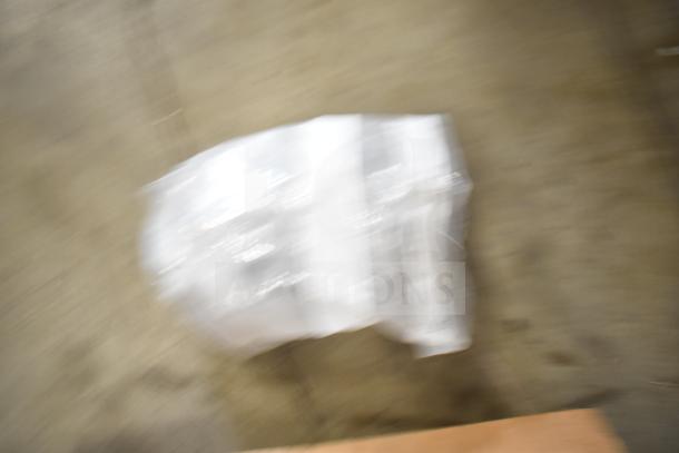 Blurred image of 29 various items including range grates and Turbochef kick plates, wrapped in packaging. Condition unclear.