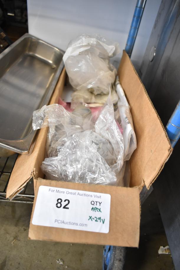 Box containing 29 various items including range grates and Turbochef kick plates, with auction label showing "82" and "29V".