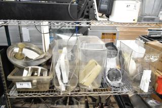 Various kitchen items including beverage machine hoppers, a meat grinder tray, vegetable chute pusher, and pelican grating blade.