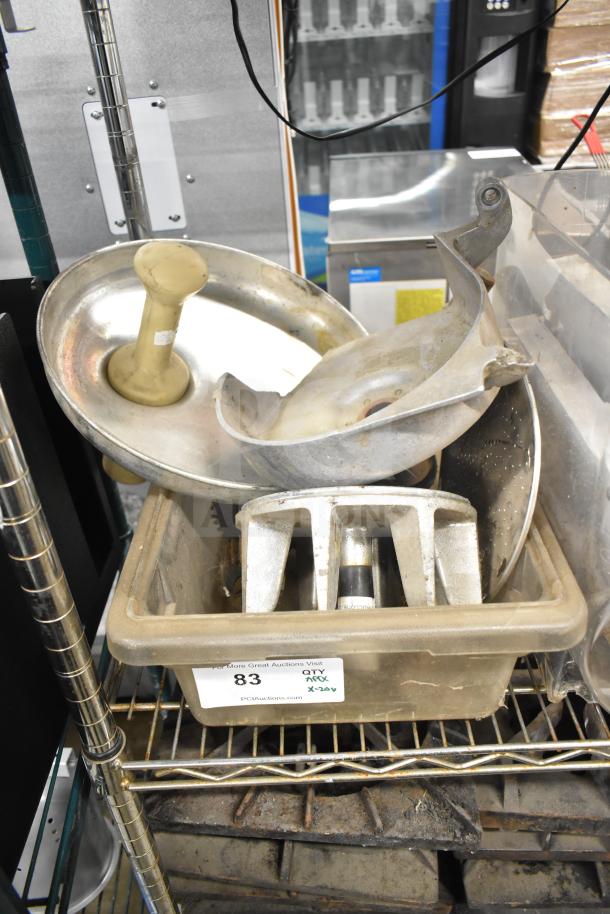 Various kitchen equipment including beverage machine hoppers, meat grinder tray, vegetable chute pusher, and pelican grating blade in a storage bin, auction lot of 20 items.