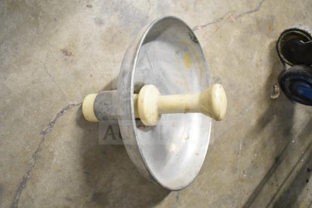 Metal vegetable chute pusher with plastic handle, part of an auction lot. Used condition, suitable for commercial machinery.