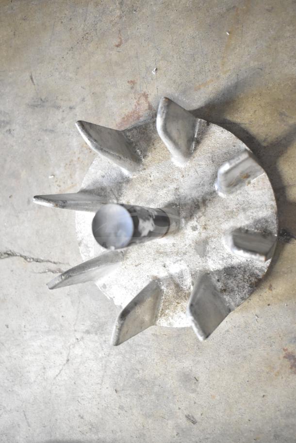 Industrial metal component with multiple angular fins, possibly part of a machine assembly, in well-used condition.