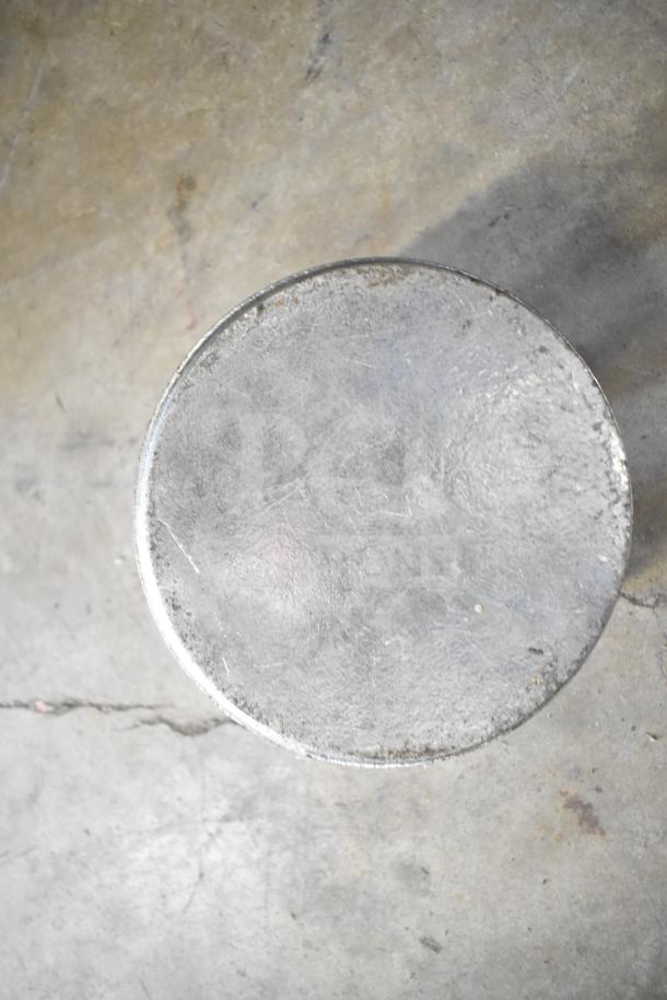 Metal circular tray on concrete floor, condition appears worn with visible scratches and scuffs. Part of a 20-item auction lot.