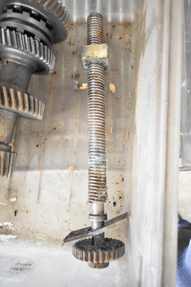 Alt text: Industrial gears, part of a lot including beverage machine hoppers, meat grinder tray, and pelican grating blade.