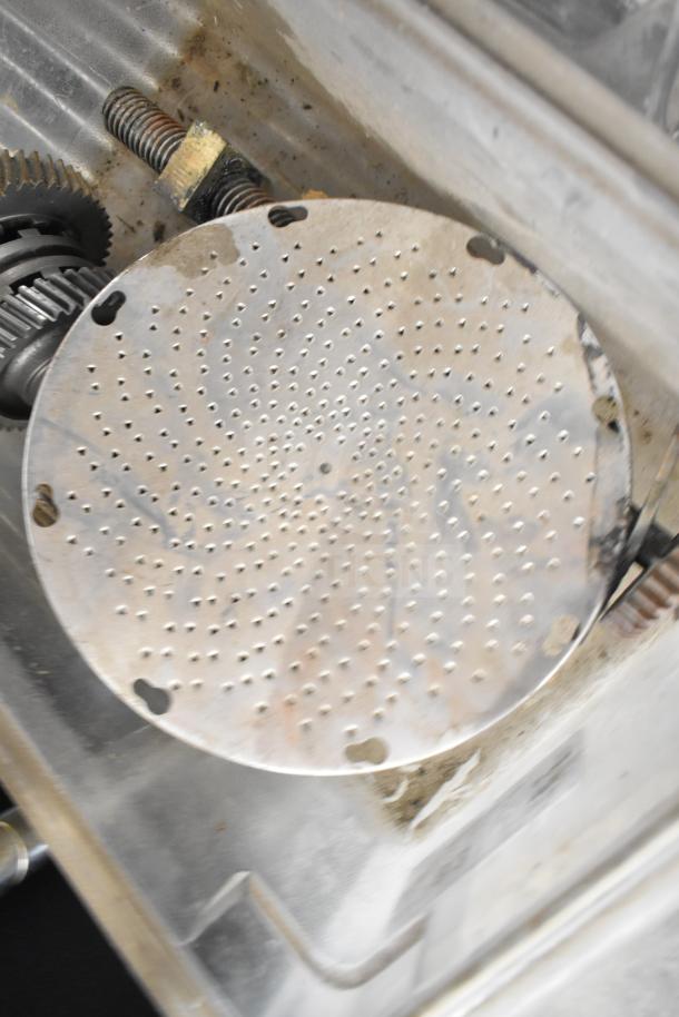 Metal grating blade with perforations, part of 20 assorted kitchen machine components. Used condition with visible wear.