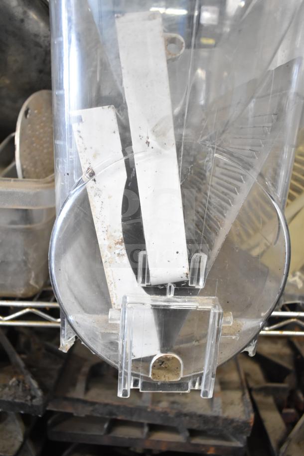 Assorted kitchen equipment including beverage machine hoppers, meat grinder tray, vegetable chute pusher, and pelican grating blade.