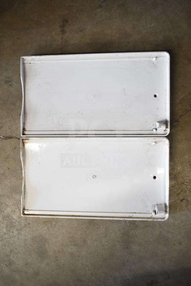 Metal trays, potentially for beverage machine hoppers. Some rust and wear visible. Set of 20 assorted items for auction.