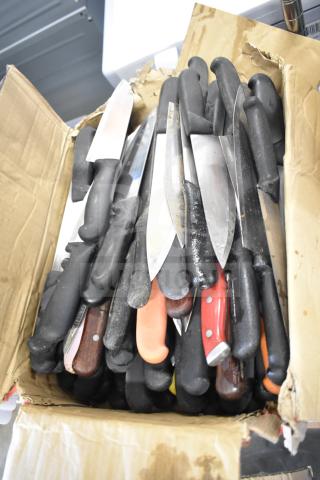 Box of 75 sharpened stainless steel chef knives with various handle styles, in good condition, ideal for bulk purchase.
