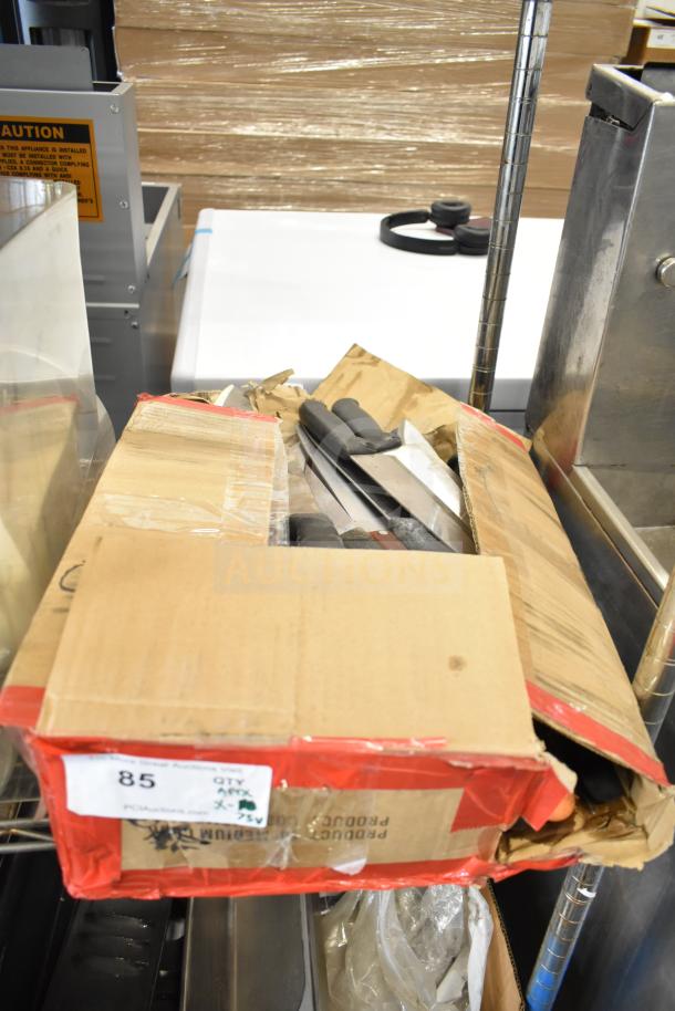 Box of 75 sharpened stainless steel chef knives, assorted handles visible. Condition appears used. Auction lot 85.