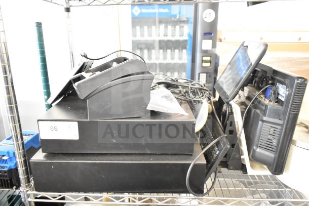 POS system with two cash drawers, receipt printer, and Toast monitor on metal shelving. Visible wiring. Item labeled "86".