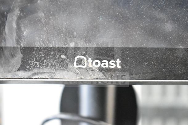 Toast POS system monitor with a visible logo.
