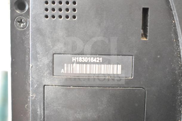 POS system rear view with barcode showing model number H183016421. Dust evident on surface. Includes 2 cash drawers and a Toast monitor.