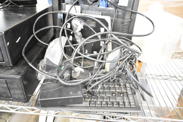 POS system with 2 cash drawers, receipt printer, Toast monitor, cables, and keyboard on a metal shelf, in used condition.