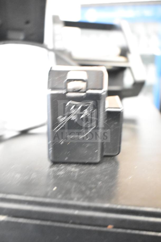 POS system with two cash drawers and receipt printer, featuring a Toast monitor. Slight wear visible. Ideal for retail use.