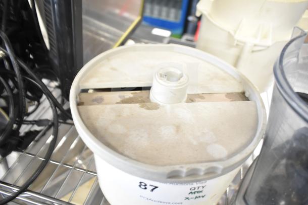 Various items including a slushie machine hopper on a shelf, showing wear. Marked "87" with auction details visible.