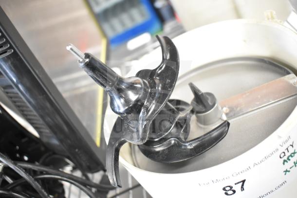 Auction items including slushie machine hoppers, slicing blade, blender pitcher. Mixed condition. Lot 87.