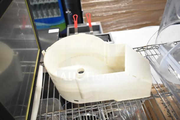 10 items including slushie machine hoppers, slicing blade, blender pitcher on a metal shelf. Mix of used parts.