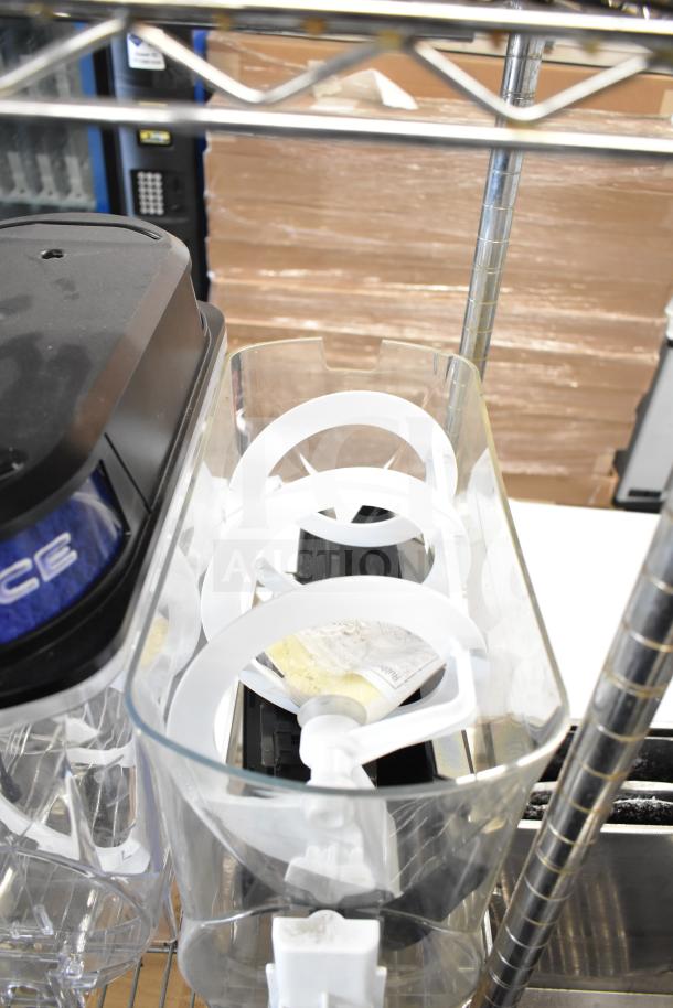 Assorted items including slushie machine hoppers, slicing blade, and blender pitcher on a metal rack.
