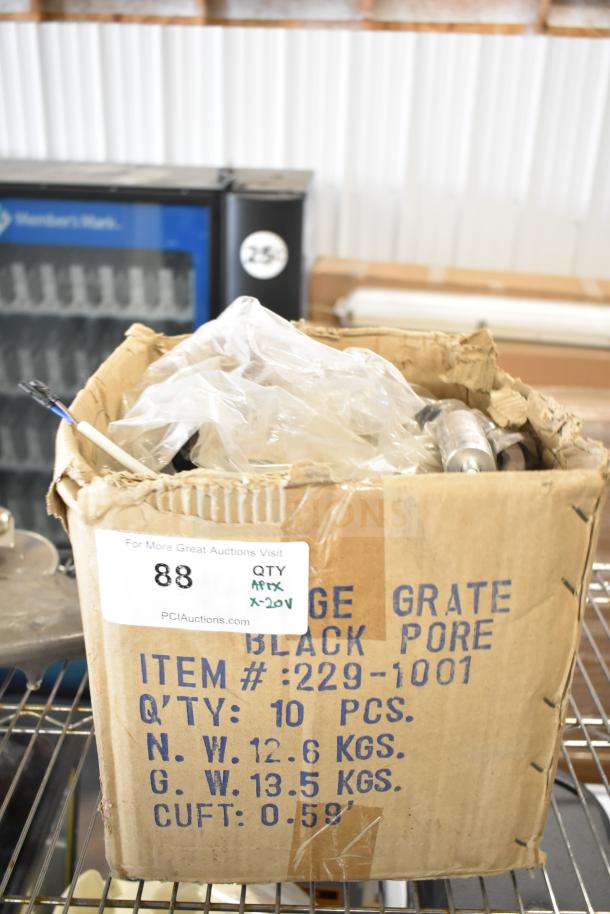 Cardboard box containing 20 various items including meat slicer arm, pelican head blades, and food processor blades. Box label indicates auction details.