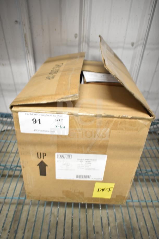 Box of DualLite EVODW double remote head lights, new condition. Labels indicate model and quantity.