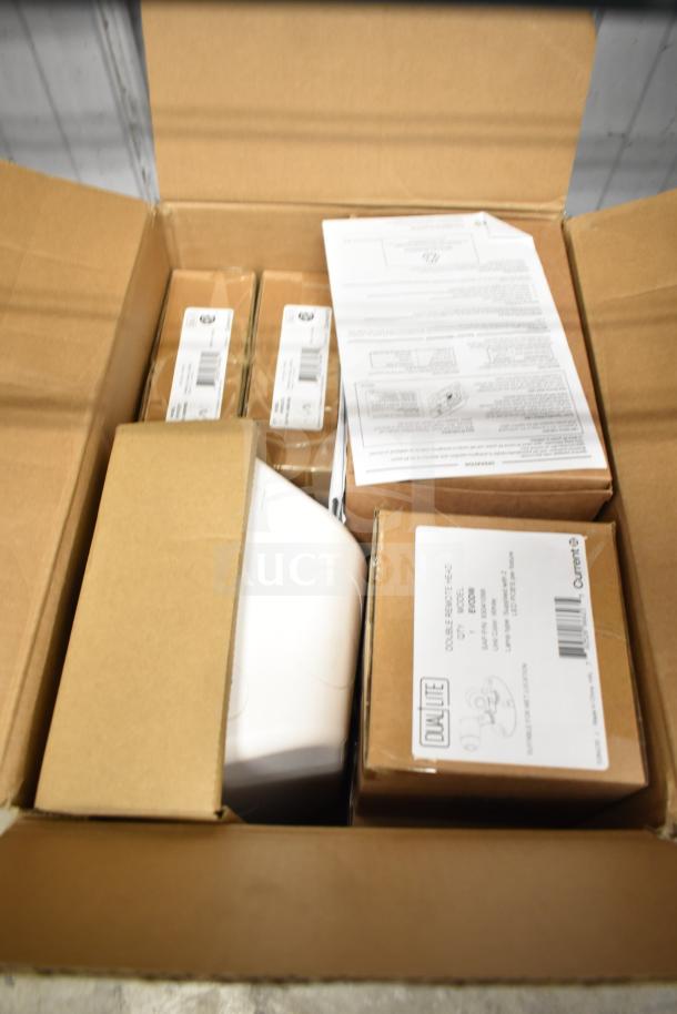 Box of DualLite EVODW Double Remote Head Light. New condition with visible labels and instruction manuals included.