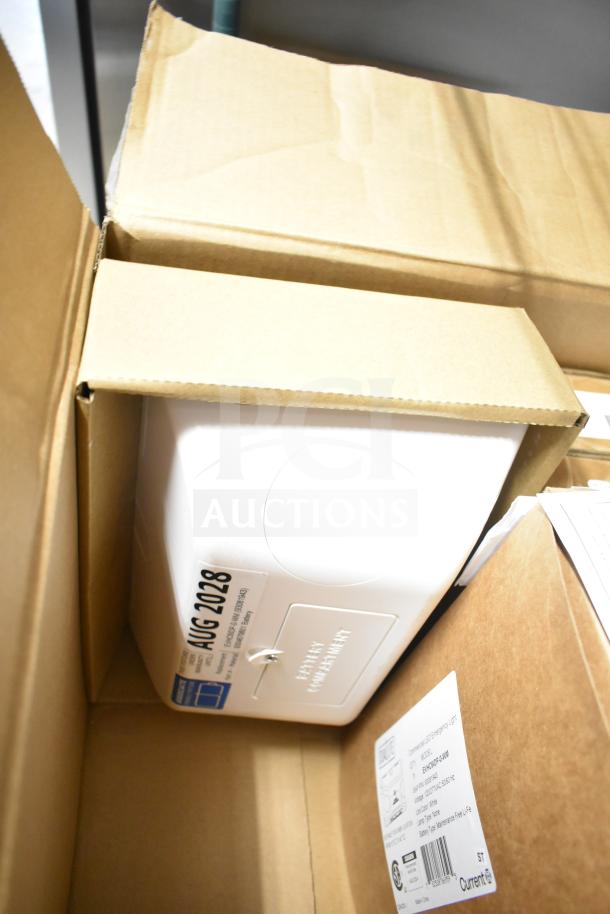 Box containing a brand new DualLite EVODW double remote head light. Visible label indicates it includes an emergency light with battery life details. The item is in original packaging.