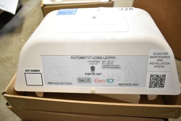 Box of DualLite EVODW Double Remote Head Light, brand new. Features automatic load learn and push to test functionality.