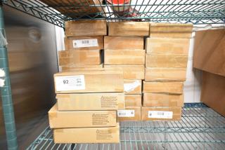 25 new DualLite EVHCEZP emergency light boxes stacked on shelving, each sealed and labeled with inventory tags.