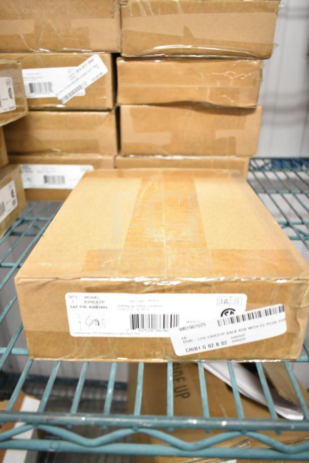 25 new boxes of DualLite EVHCEZP Emergency Lights, sealed in original packaging, ready for auction. Model details visible.