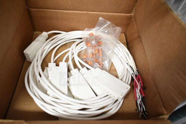 Box containing brand new ERP VLM100W-24 ballasts with cables and connectors, ready for installation.