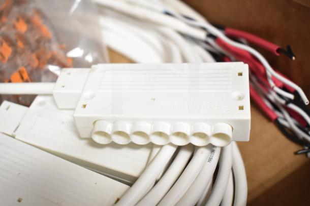 Brand new ERP VLM100W-24 ballasts in packaging, visible cables, and connectors for electrical applications.