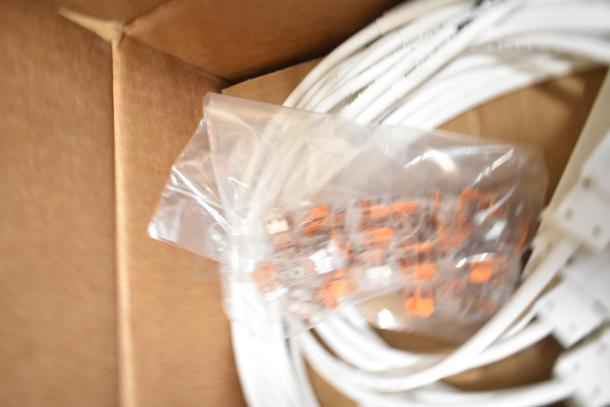 Four new boxes of ERP VLM100W-24 ballasts, sealed in plastic, with cables and connectors, ready for auction.