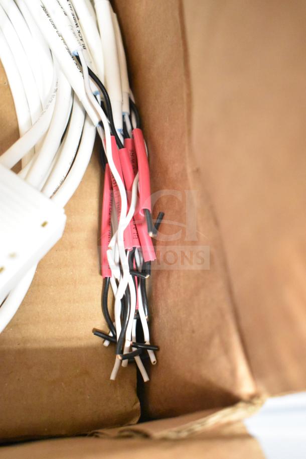 Four boxes with ERP VLM100W-24 ballasts, brand new, showing bundled wires and connectors.