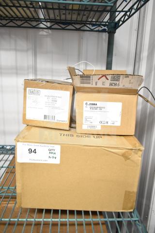 11 brand new boxes of DualLite EVODW Double Remote Head Lights, EBP Ballasts, and DualLite DYN6I-WM on metal shelf.