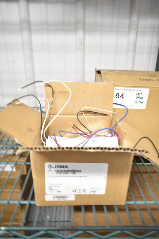 11 brand new boxes: DualLite EVODW Double Remote Head Light, EBP Ballasts, DualLite DYN6I-WM. Wires visible.