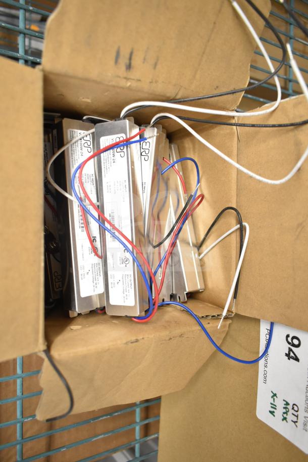 Boxes of DualLite EVODW Double Remote Head Lights, EBP Ballasts, DualLite DYN6I-WM, all new with wiring visible.