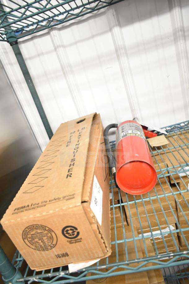New Sentry fire extinguisher beside its original packaging on a metal shelf; labeled 10 lb with safety markings.