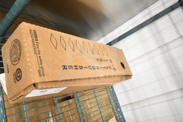Brown box containing a Sentry fire extinguisher, 10 lb, branded by FEMA, marked as new in packaging.